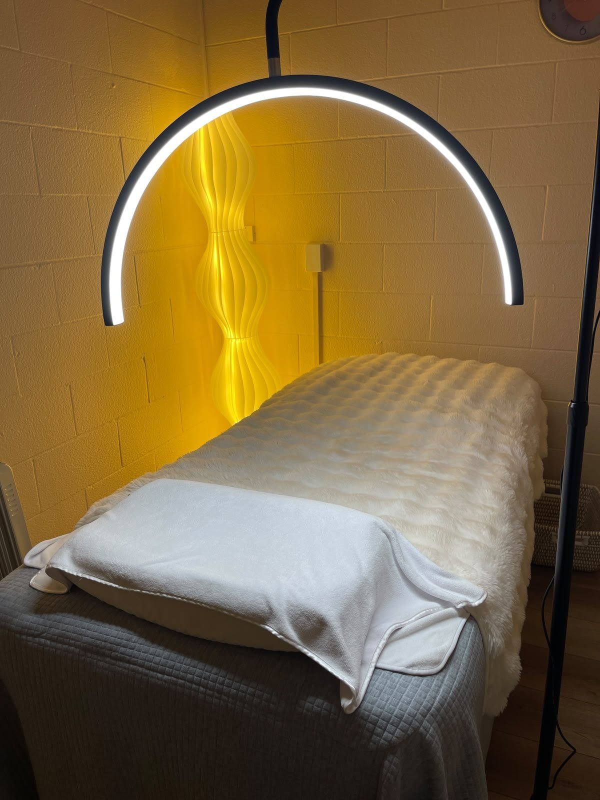 Facial treatment bed with LED lamp